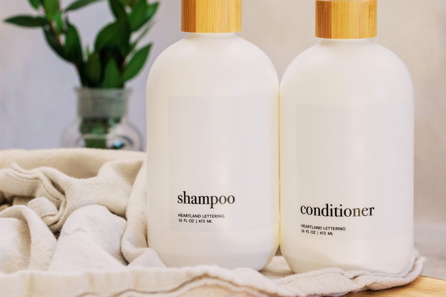 Shampoo and Conditioner Bottles on a Table